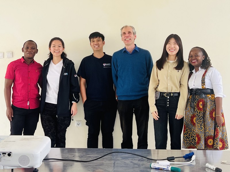 Six Hub researchers and partners stand together smiling at the camera